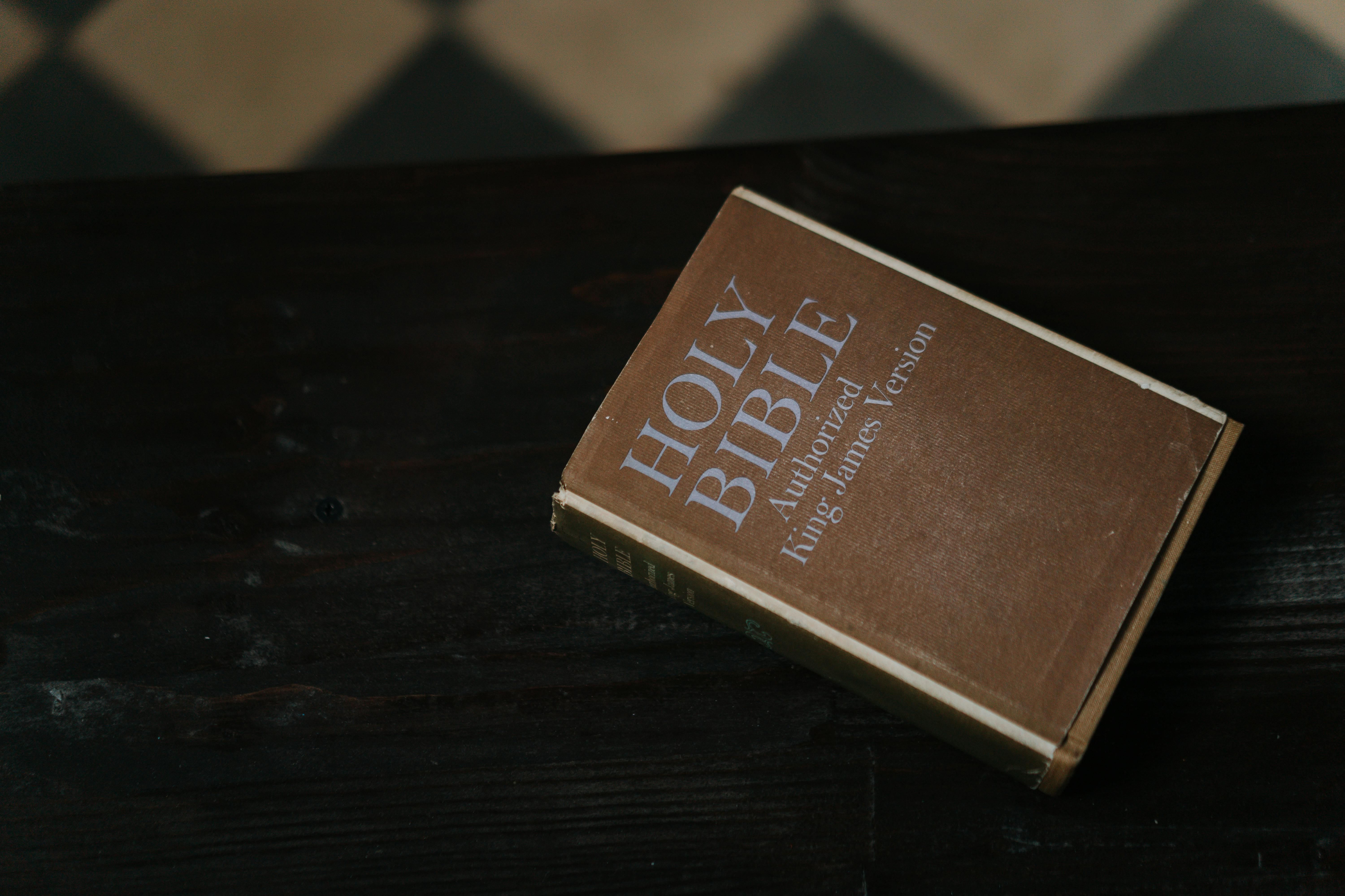 An Authorized King James Version Holy Bible resting on a dark wooden table.